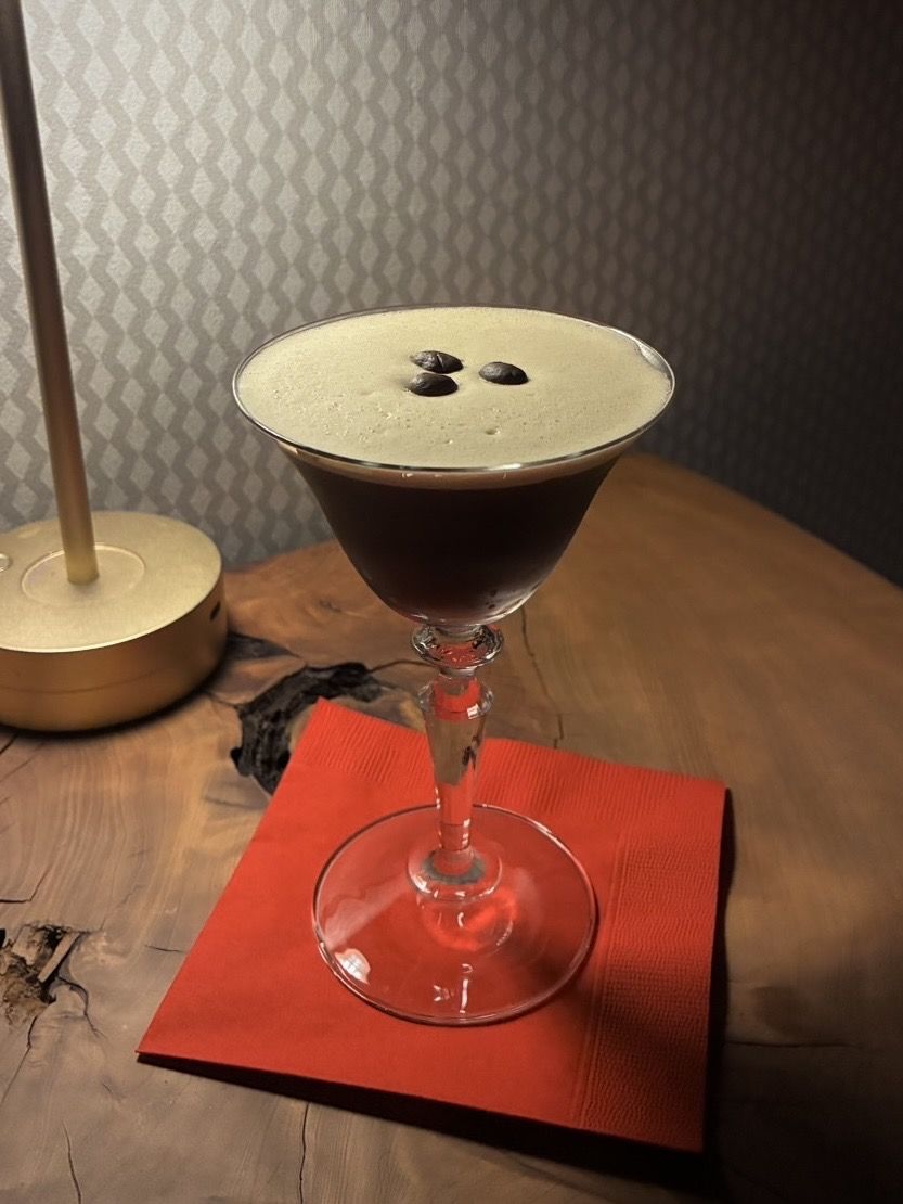 Espresso Martini with a thick crema and three coffee beans
